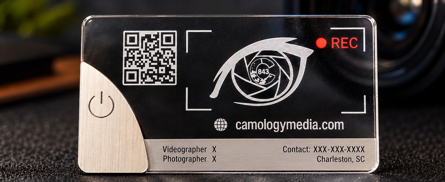 Camology Media sample acrylic business card with metal power-button corner and X placeholders
